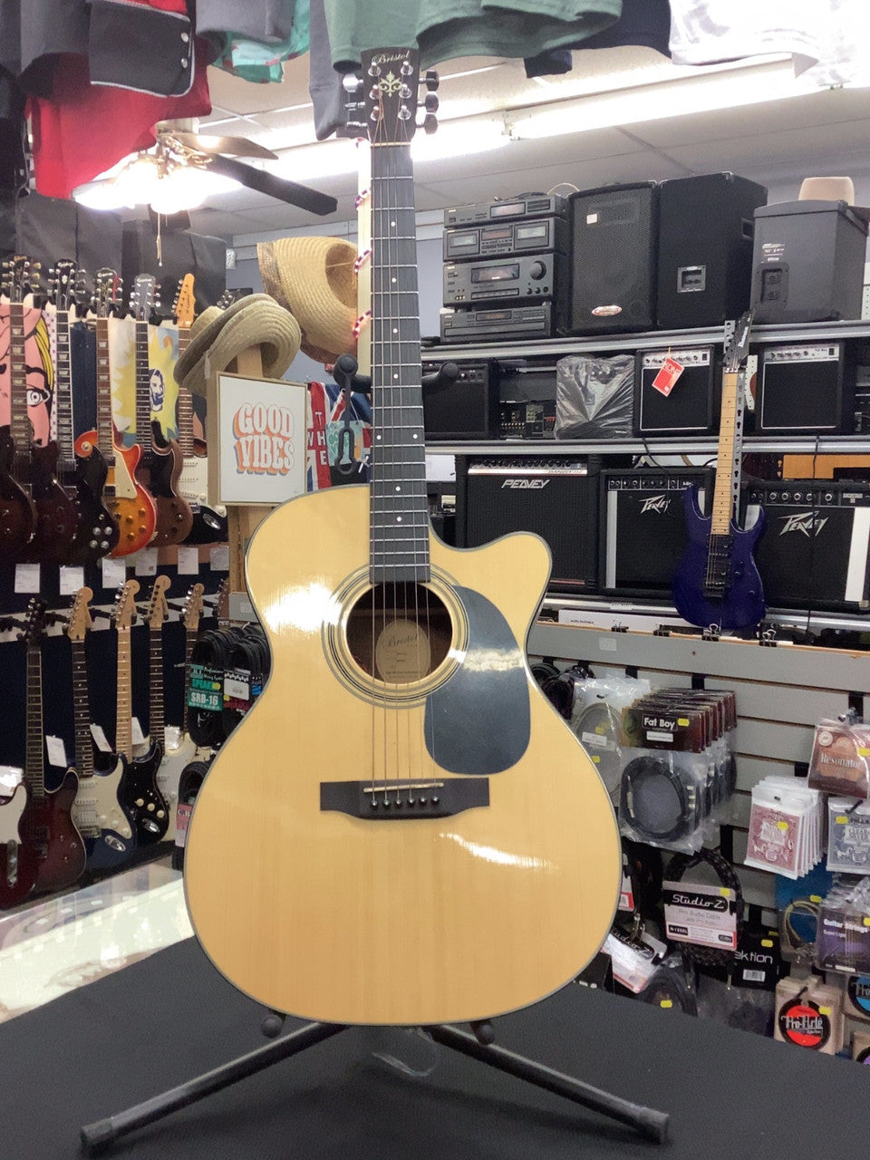 Here we have a Bristol BM-16CE Acoustic Guitar. This is my personal favorite of the acoustics we have in the shop. Its sound strikes the perfect balance between low and high. It feels absolutely fantastic.